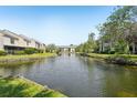 Scenic water view showcasing serene lake and surrounding lush green landscaping at 13602 Frigate Ct # N201, Clearwater, FL 33762