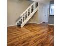 Living room with new flooring and staircase leading to upper level at 14061 Notreville Way, Tampa, FL 33624