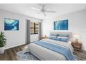 Calming bedroom with blue accents, hardwood floors, large windows and natural light at 14255 Rosemary Ln # 8219, Largo, FL 33774