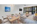 Bright and airy living room with modern furniture, a large sliding door, and contemporary decor at 14255 Rosemary Ln # 8219, Largo, FL 33774