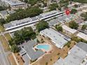 Aerial view of a condominium complex with a central pool and well-maintained landscaping at 1655 S Highland Ave # C155, Largo, FL 33756