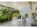 Covered patio featuring comfortable seating, plants, and a garden view, perfect for relaxation at 1655 S Highland Ave # C155, Largo, FL 33756