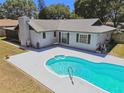 Backyard featuring a kidney shaped pool with a large deck and screened in patio at 2204 Jennifer Ln, Valrico, FL 33594