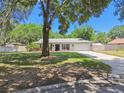 Well-maintained home with a lovely lawn, mature trees, and a two-car garage at 2204 Jennifer Ln, Valrico, FL 33594