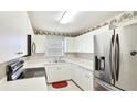 Efficient kitchen featuring white cabinets, stainless steel appliances, and ample counter space at 2314 50Th E Dr, Bradenton, FL 34203