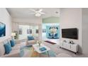 Bright living room with vaulted ceilings, sliding doors, and an adjacent dining area offers comfortable seating at 2314 50Th E Dr, Bradenton, FL 34203