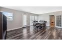 Dining area with wood floors, a sliding glass door, and modern lighting at 4715 W Montgomery Ave, Tampa, FL 33616