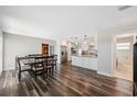 Bright dining room featuring wood floors, white cabinets, and stainless steel appliances at 4715 W Montgomery Ave, Tampa, FL 33616