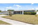 Charming single-story home featuring a covered carport and well-maintained front lawn at 4715 W Montgomery Ave, Tampa, FL 33616