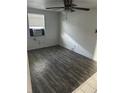 Bedroom features dark wood laminate flooring, ceiling fan and window at 5829 32Nd N St, St Petersburg, FL 33714