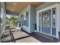 Inviting front porch with rocking chairs and coastal decor offering a relaxing outdoor space at 718 Manns Harbor Dr, Apollo Beach, FL 33572