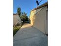 Home exterior featuring a long, concrete driveway and low-maintenance side yard at 7601 Como Dr, New Port Richey, FL 34655