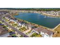 An aerial view of neighborhood houses and a lake, displaying the community setting and waterfront access at 7782 Sail Clover Ln, Zephyrhills, FL 33540
