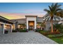 Stately home featuring stone paver driveway and manicured landscaping at 813 Manns Harbor Dr, Apollo Beach, FL 33572