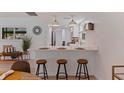 Bright kitchen with quartz breakfast bar, stainless appliances, and pendant lighting at 8401 Stillbrook Ave, Tampa, FL 33615