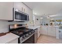 Modern kitchen featuring stainless steel appliances, quartz countertops, and stylish fixtures at 8401 Stillbrook Ave, Tampa, FL 33615