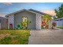 Charming single-story home with a well-maintained lawn and beautiful stone accents at 9112 Suffield Ct, Tampa, FL 33615
