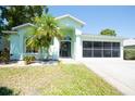 Charming single-story home with a well-maintained lawn and palm tree at 10321 Ravines Dr, New Port Richey, FL 34654