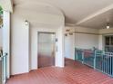 Building hallway with elevator access, ceramic tile floors, and outdoor seating at 1042 Bellasol Way # 202, Apollo Beach, FL 33572