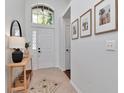 Inviting entryway with neutral tile, leading to a bright, airy interior with an arched window above the front door at 12327 Glenfield Ave, Tampa, FL 33626
