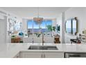 Modern kitchen view with stainless appliances and a stunning view of the ocean in the background at 1325 Snell Isle Ne Blvd # 911, St Petersburg, FL 33704