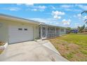 Inviting one-story home featuring a one-car garage and screened porch, offering a blend of comfort and curb appeal at 1410 Lime St, Clearwater, FL 33756