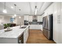 Bright modern kitchen with white cabinets, stainless steel appliances, and large island at 202 Windward Psge # 304, Clearwater Beach, FL 33767