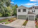 Charming townhome with a two-car garage, well-kept landscaping, and a clean, neutral-toned exterior at 2531 Earlswood Ct, Brandon, FL 33510