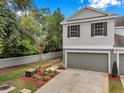 Attractive townhome featuring an attached garage, neat landscaping, and a well-maintained neutral exterior at 2531 Earlswood Ct, Brandon, FL 33510