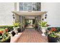The building entrance features a brick walkway, plants, and glass doors to the interior at 2699 Seville Blvd # 705, Clearwater, FL 33764
