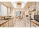 Bright, functional kitchen featuring dual countertops and cozy breakfast table with a fan fixture above at 2699 Seville Blvd # 705, Clearwater, FL 33764