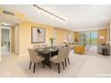 Open-concept living and dining room with plenty of natural light and neutral color palette at 2699 Seville Blvd # 705, Clearwater, FL 33764