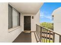 Private covered patio with railing, offering an intimate outdoor space at 2699 Seville Blvd # 705, Clearwater, FL 33764