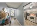 Bright entryway with tile flooring that offers a glimpse of the kitchen, featuring stainless appliances at 319 Kelsey Way, Sun City Center, FL 33573