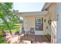Cozy covered front porch with seating area, perfect for enjoying the outdoors in a quaint space at 319 Kelsey Way, Sun City Center, FL 33573