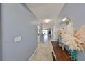 Inviting hallway with tiled flooring, leading into the main living areas with soft blue walls at 319 Kelsey Way, Sun City Center, FL 33573