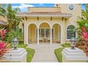 Inviting front porch featuring elegant columns, stylish seating, and views of beautiful landscaping at 3215 W Fair Oaks Ave, Tampa, FL 33611