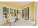 Cozy front porch with unique wicker chairs and decorative details, creating a relaxing outdoor space at 3215 W Fair Oaks Ave, Tampa, FL 33611