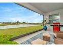 Relaxing lanai with lake view, stylish rug, and comfortable outdoor furniture, perfect for enjoying the serene scenery at 3504 Golden Wheat Ln, Plant City, FL 33565