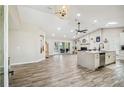 Open-concept living space with wood floors, a fireplace, and sliding glass doors to the outdoor area at 4368 Marine Pkwy, New Port Richey, FL 34652