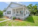 Charming home featuring a porch, white siding, black shutters, and landscaped yard at 4568 18Th S Ave, St Petersburg, FL 33711