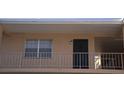 Exterior view of condo with secure front door, balcony and large window at 4724 Michael Ct # 122, Tampa, FL 33614
