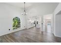 Bright, open-concept living area with modern flooring and large arched window at 6302 Silver Oaks Dr, Zephyrhills, FL 33542