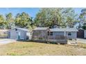 View of the side of the house with garage and enclosed wooden patio at 9236 Suncoast Terrace, Hudson, FL 34667