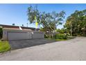 Attached two-car garage offers convenience, complemented by a well-maintained driveway and mature landscaping at 10605 Carrollbrook Ln, Tampa, FL 33618