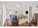 Bright living room with hardwood floors, vaulted ceiling, and a staircase leading to the upper level at 10605 Carrollbrook Ln, Tampa, FL 33618