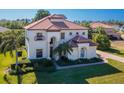 Beautiful two-story home featuring a red tile roof, well-kept lawn, and professional landscaping at 10528 Bermuda Isle Dr, Tampa, FL 33647