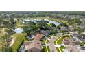 Aerial view showcases a house near a golf course, providing scenic views and recreational opportunities at 11209 Pocket Brook Dr, Tampa, FL 33635