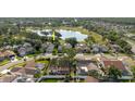 An aerial view shows the home is close to a pond and golf course with mature trees on the property at 11209 Pocket Brook Dr, Tampa, FL 33635