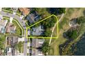 An aerial view showcases the home's proximity to a golf course and lake, highlighted by a yellow outline at 11209 Pocket Brook Dr, Tampa, FL 33635
